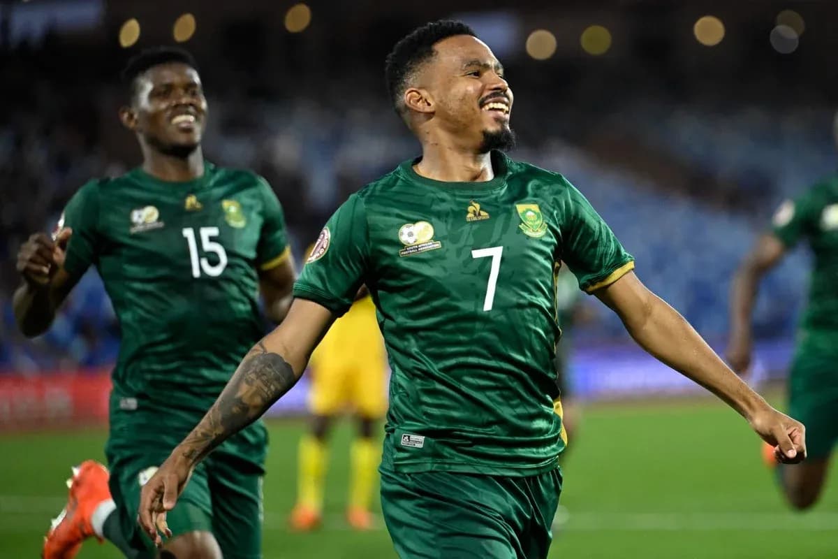 Player celebrating a goal with teammates during match