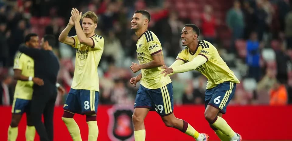 Players celebrating victory on the pitch after match