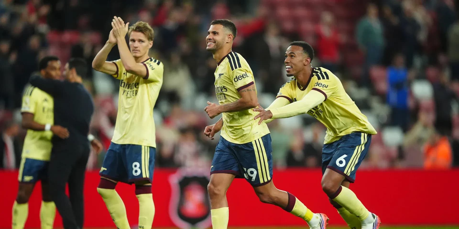 Players celebrating victory on the pitch after match