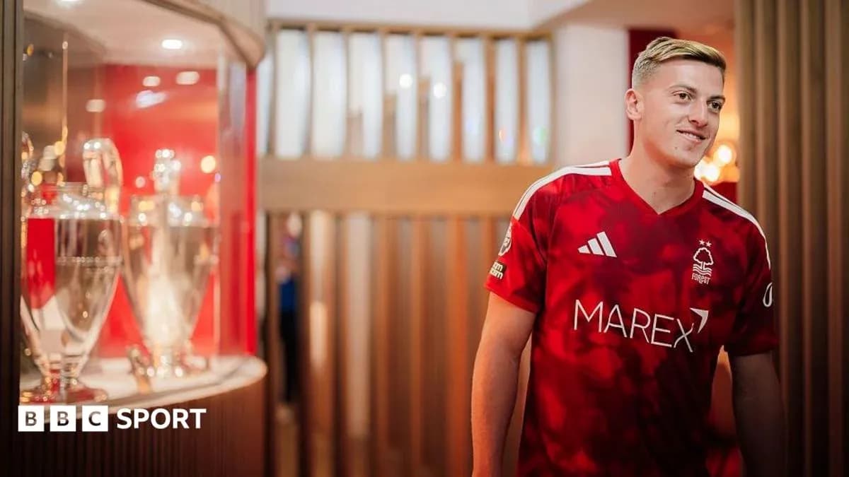 Player in Nottingham Forest jersey near trophies display
