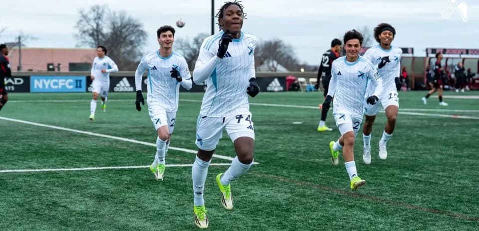New England II players celebrating a goal