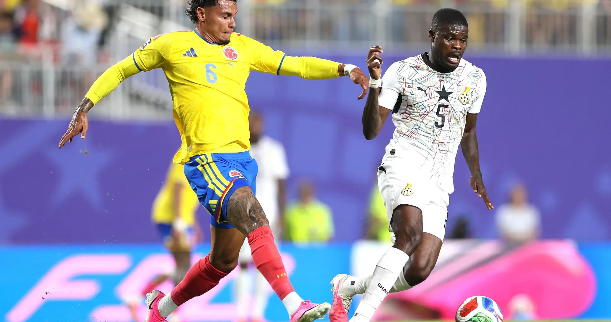 Colombia player challenges Ghana opponent during match