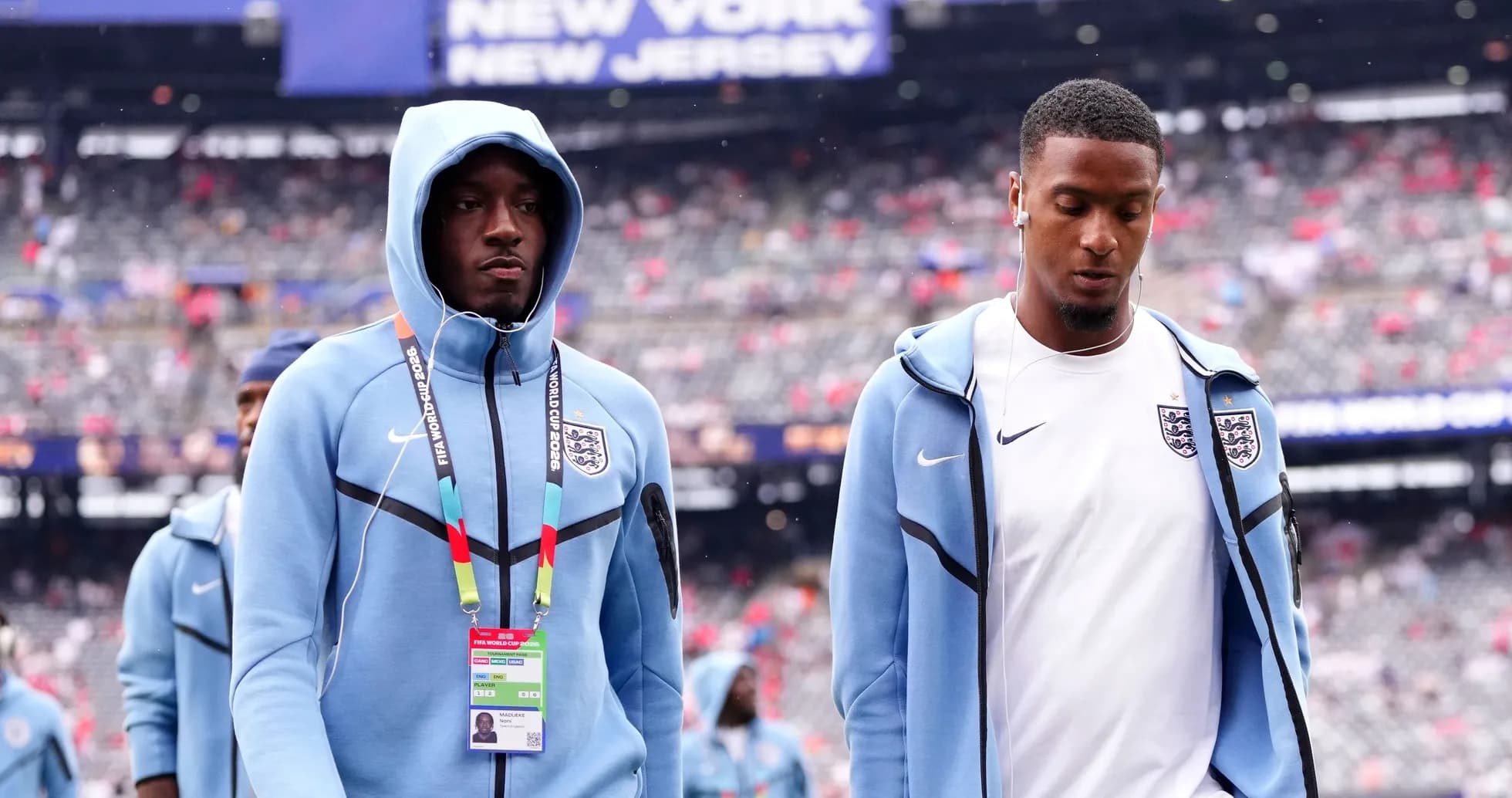 Two England players walking onto the pitch