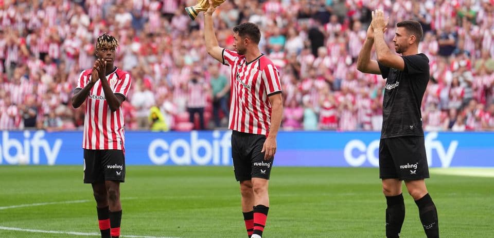 Athletic Bilbao players celebrating with trophy at stadium