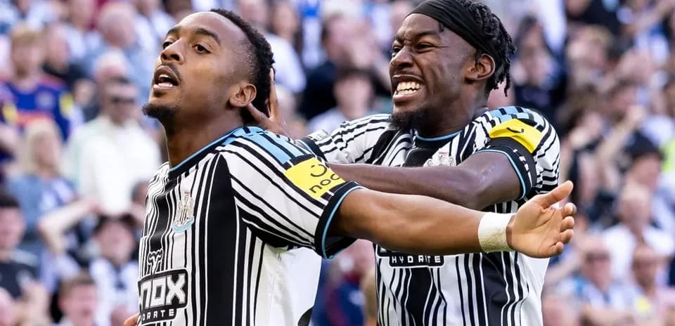 Newcastle players celebrating a goal in stadium
