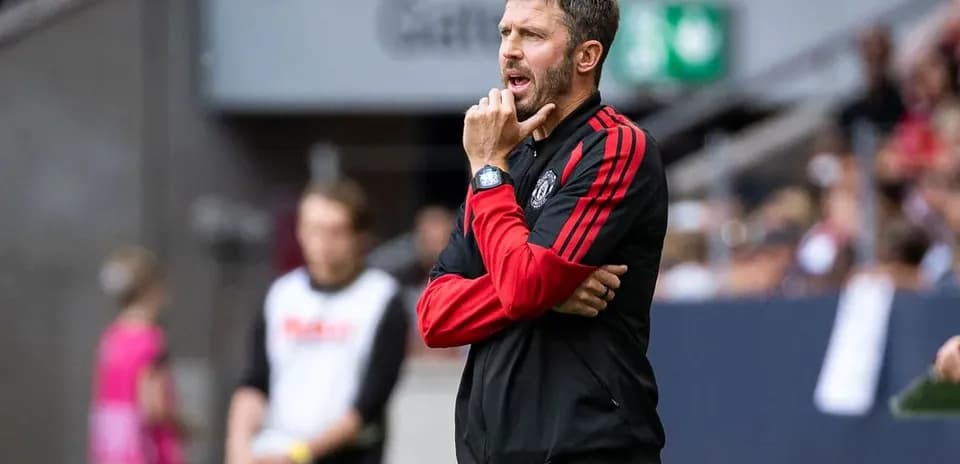Coach observing match from sidelines with thoughtful expression