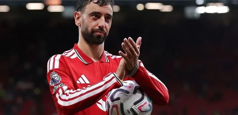 Player applauding while holding a football