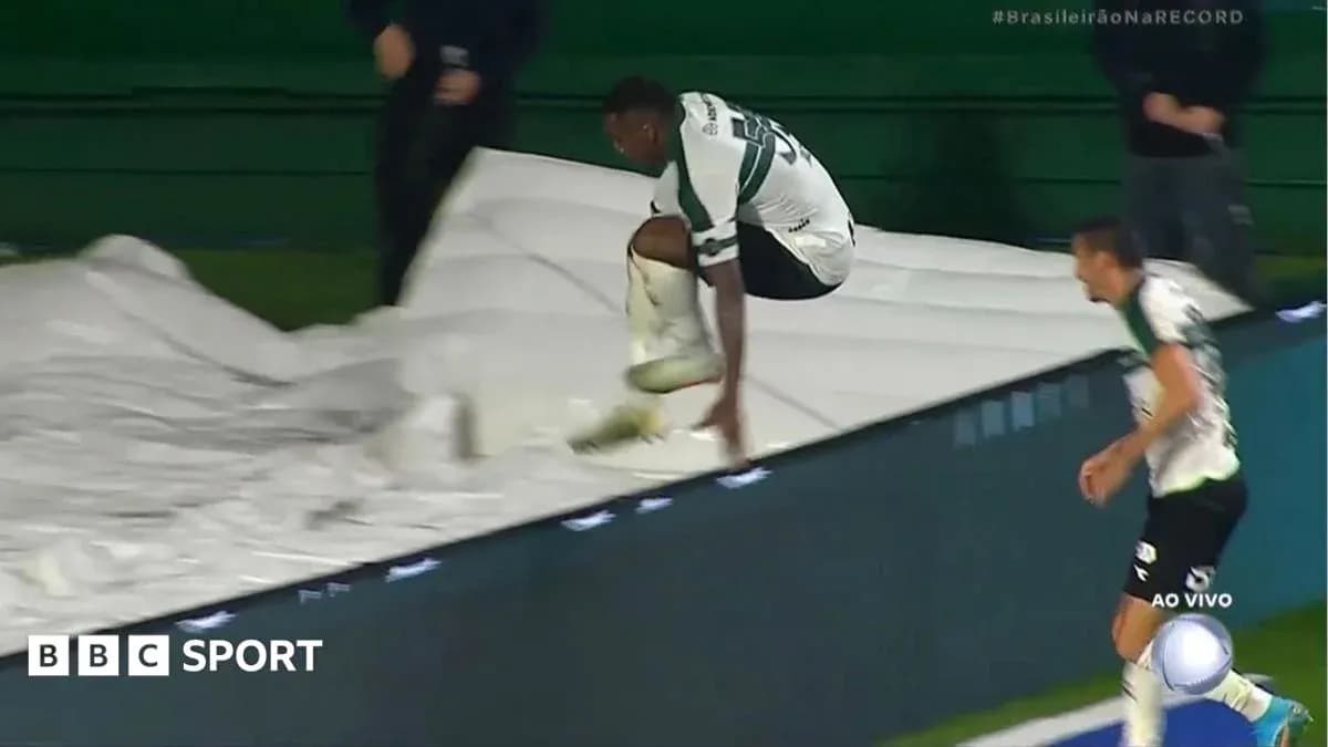 Player jumping over advertising board during match