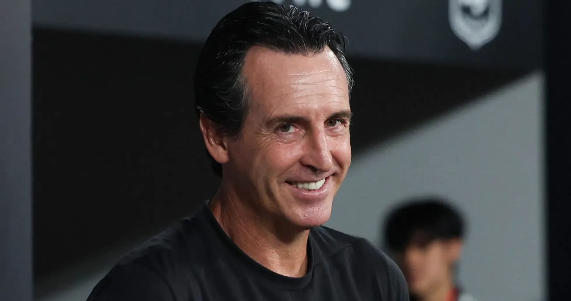 Coach smiling on the sidelines during match