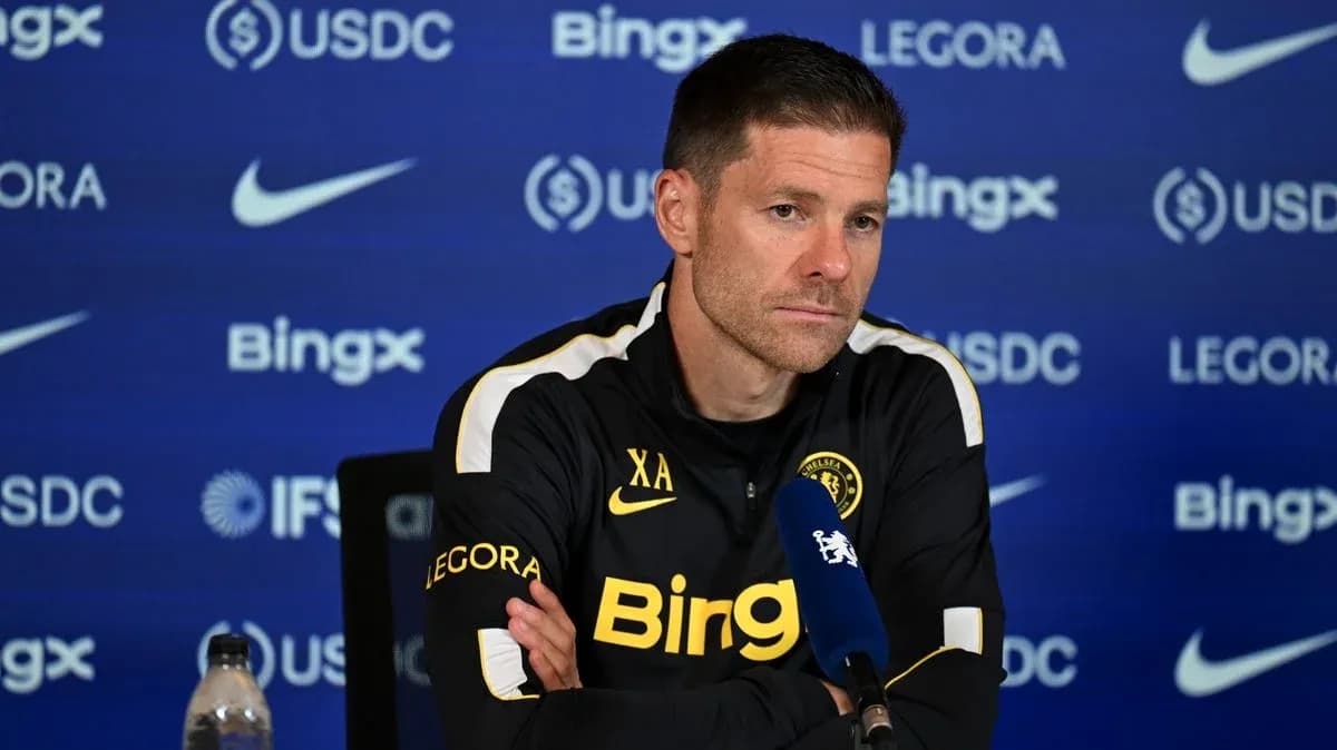 Manager at press conference with team logo backdrop