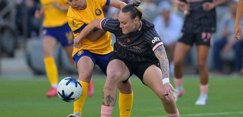 Two players competing for the ball in match