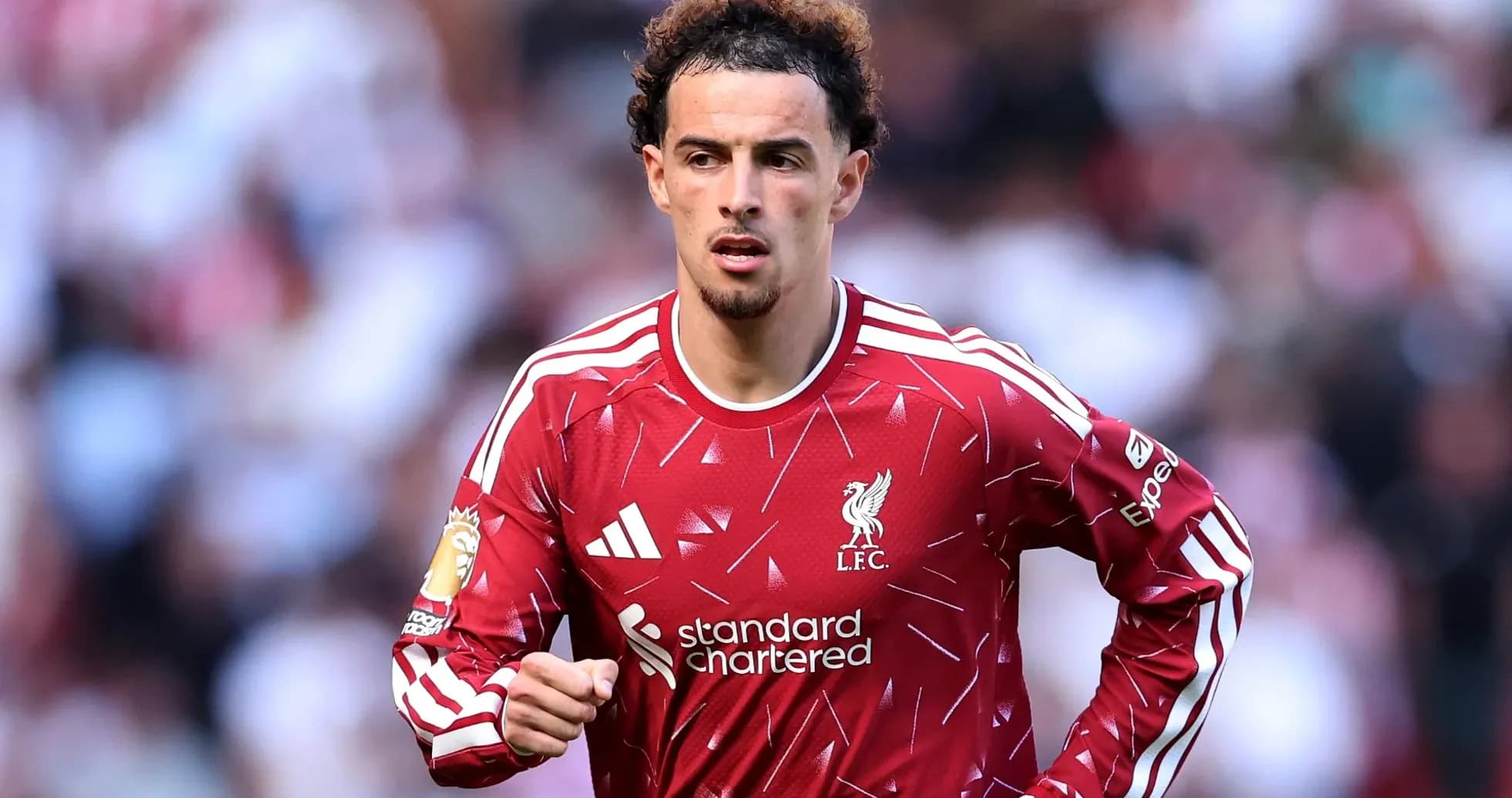 Player running on the field in Liverpool kit