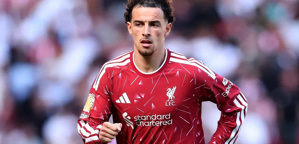 Player running on the field in Liverpool kit