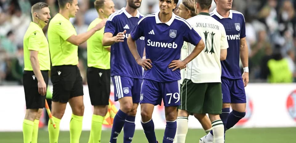 Anderlecht players discussing with referees during match