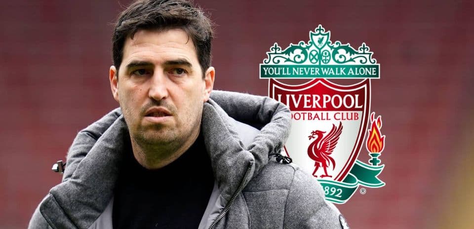 Coach in front of Liverpool FC club logo