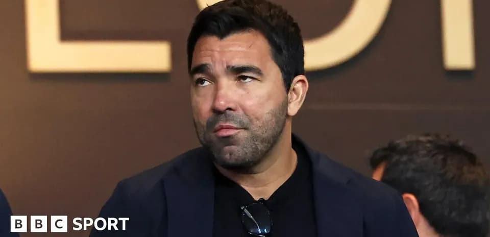 Man in suit attending event, looking thoughtful