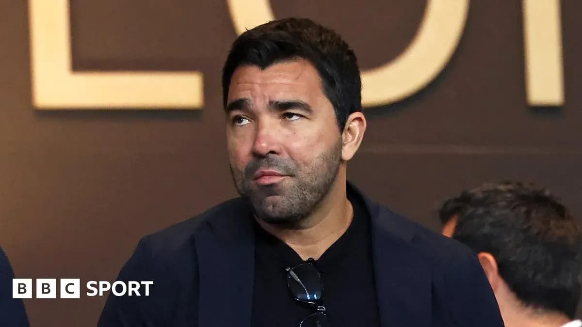 Man in suit attending event, looking thoughtful