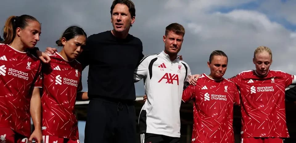Liverpool women's team huddled with coaching staff