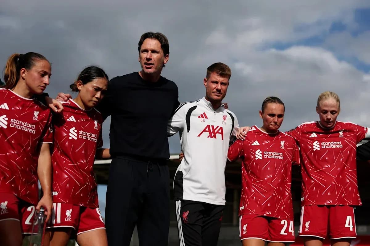 Liverpool women's team huddled with coaching staff