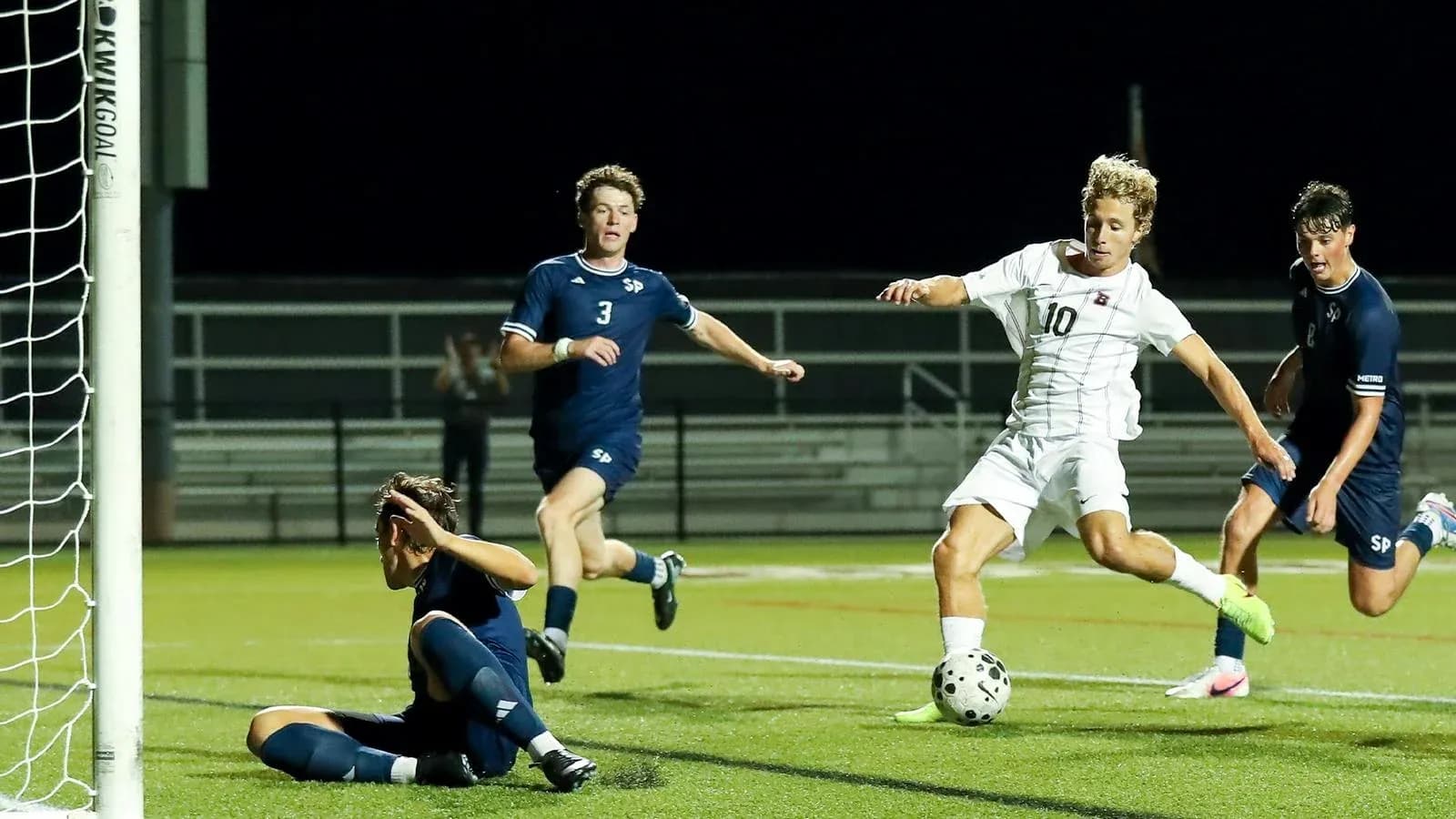 Player attempting to score as goalkeeper reacts