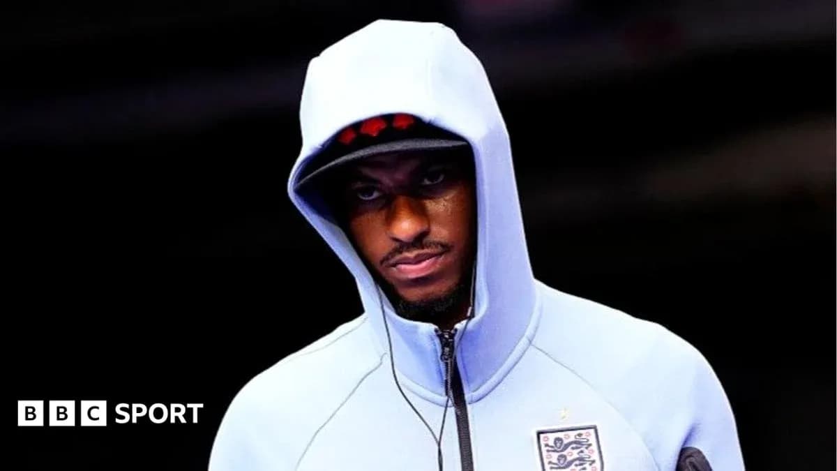 Player wearing a hoodie before the match
