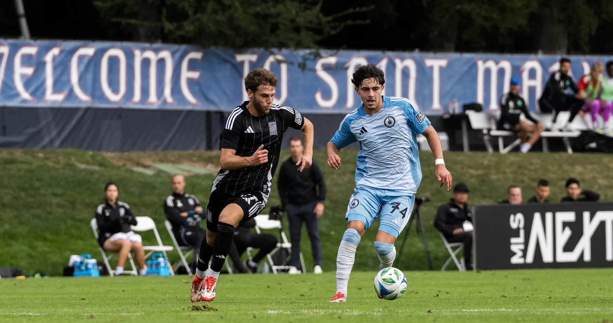 Two players competing for the ball in football match