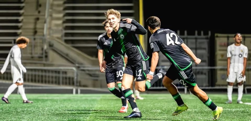 Players celebrating a goal during Austin II match
