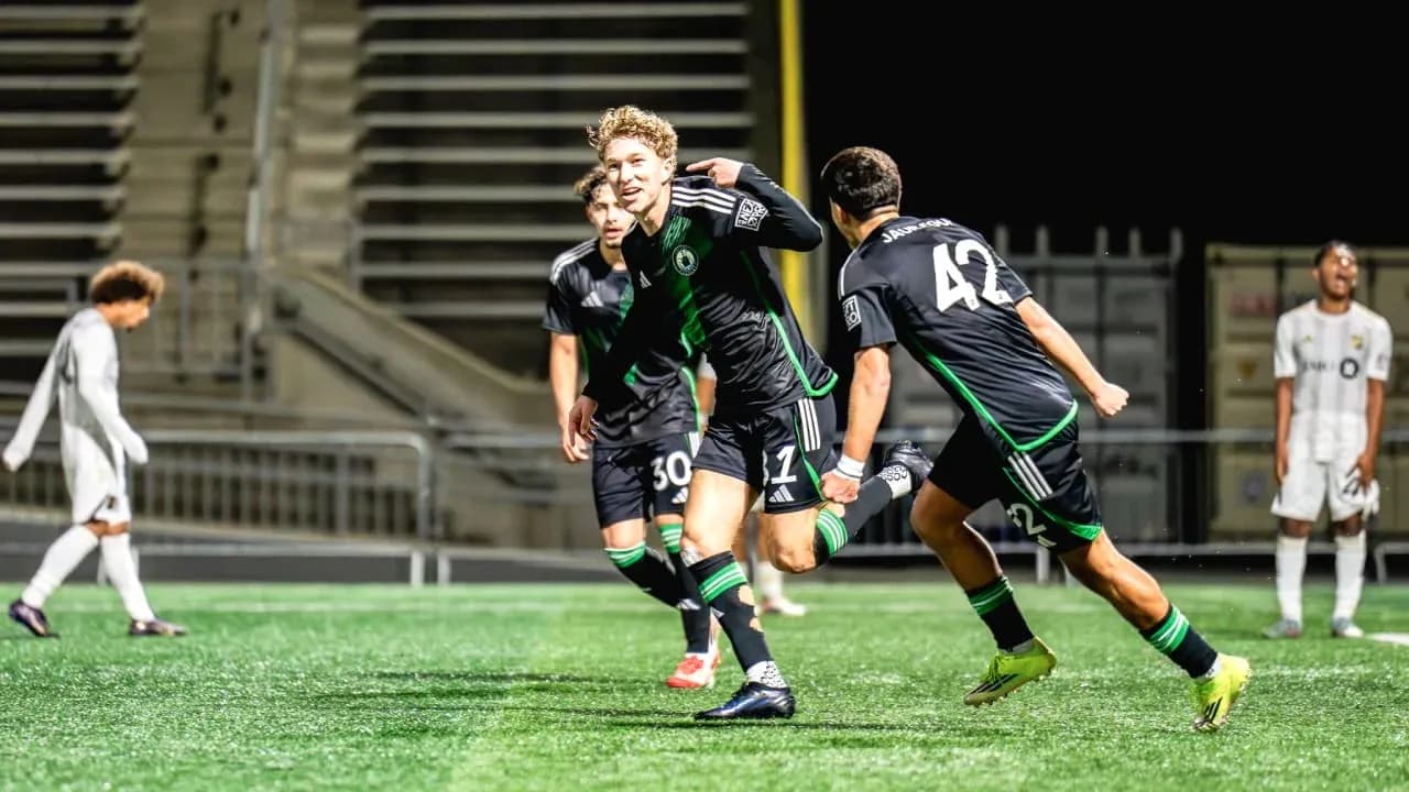 Players celebrating a goal during Austin II match