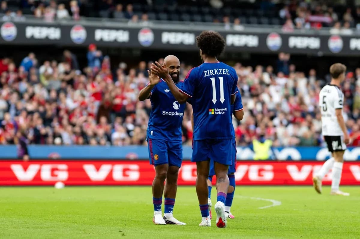 Two players celebrating on the pitch during match