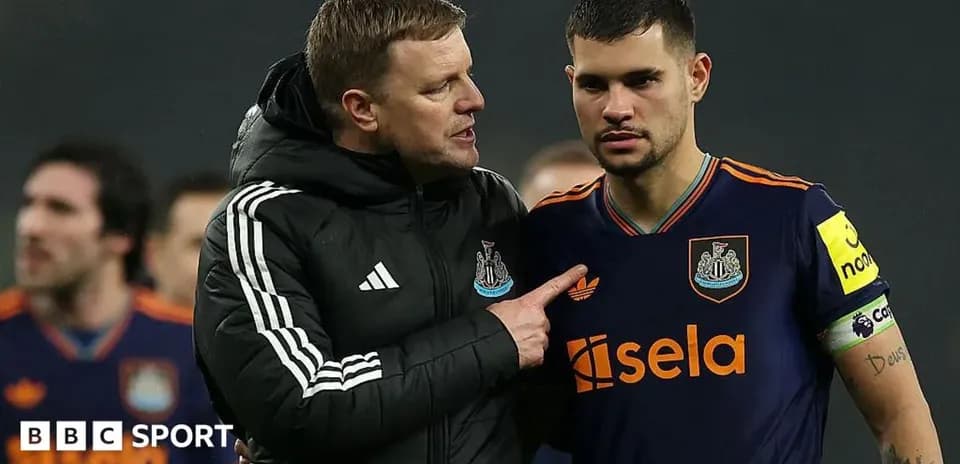 Manager speaking to player on the field after match