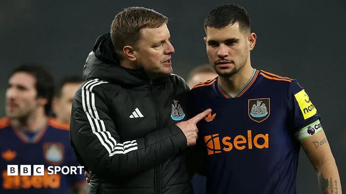 Manager speaking to player on the field after match