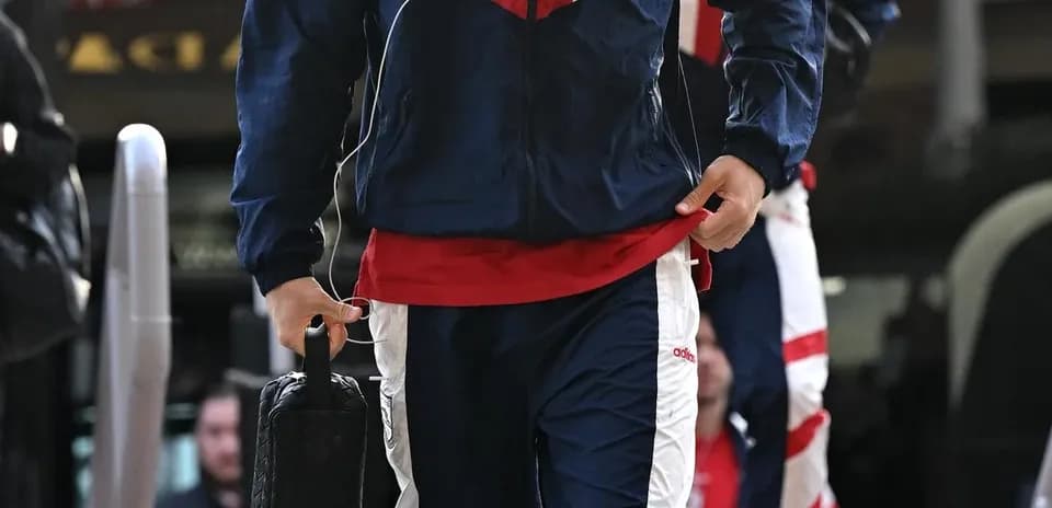Player arriving in team tracksuit before match