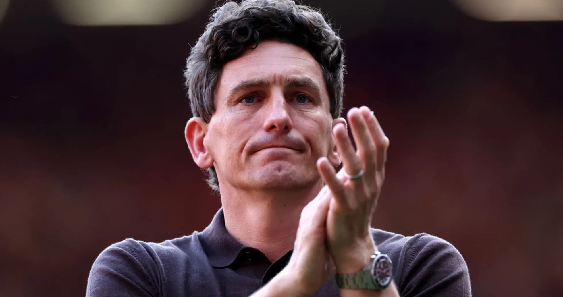 Manager applauding during match at stadium