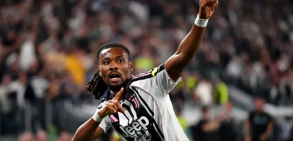 Player celebrating goal with raised finger in stadium
