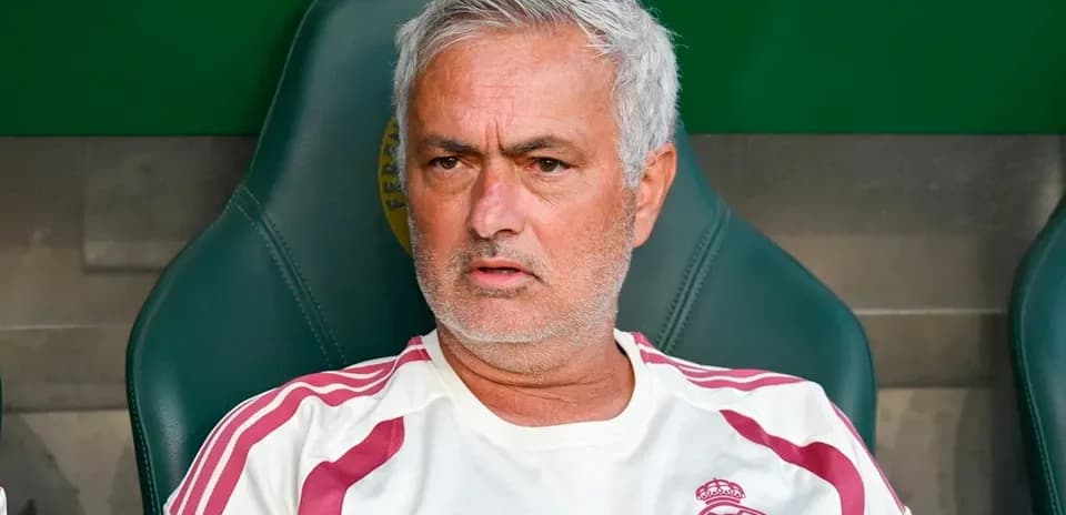 Coach sitting on bench during match