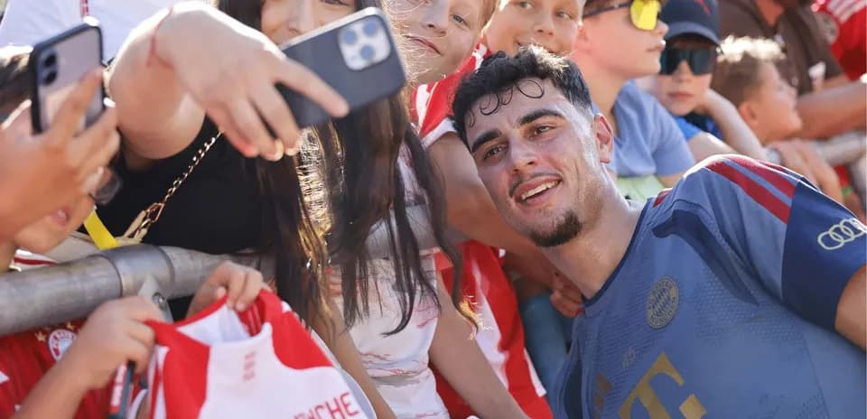 Player taking selfie with young fans after match