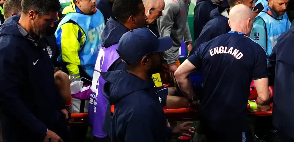 Medical staff assisting player on stretcher during match