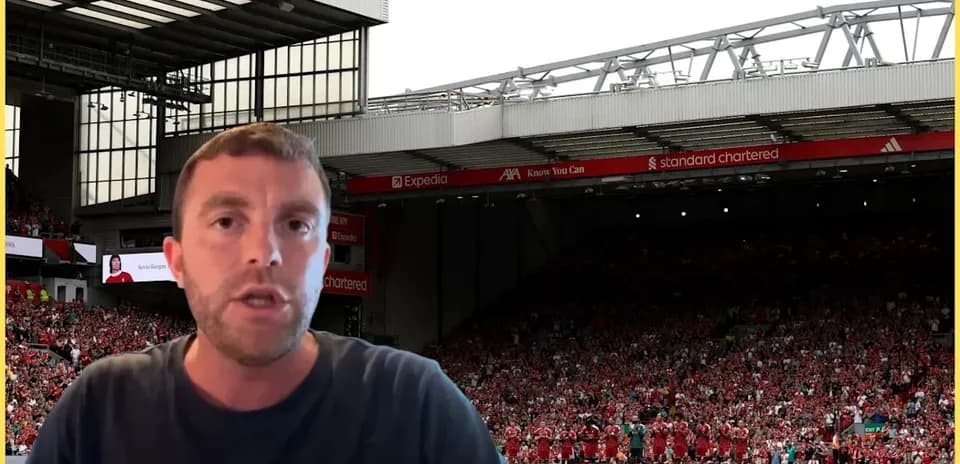 Presenter speaking with Liverpool players in background