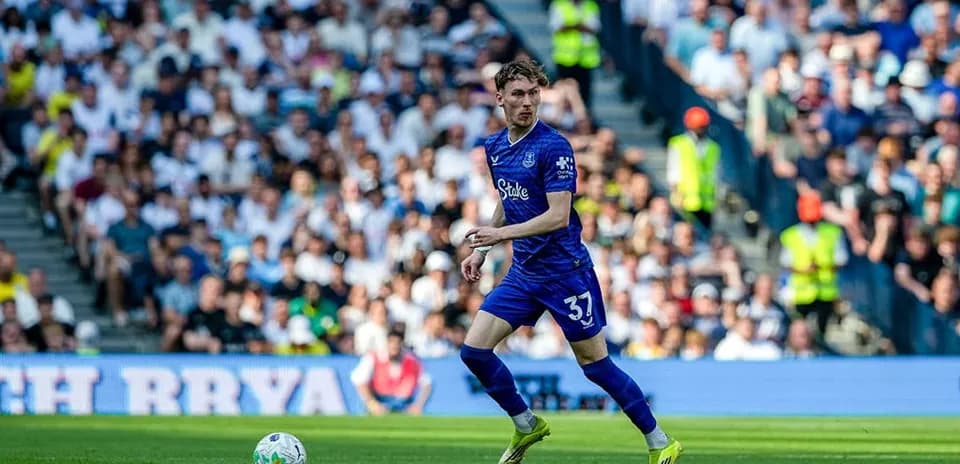 Player in blue jersey running with ball during match