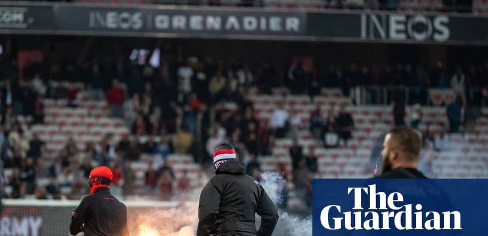 Fans igniting flares in stadium during match