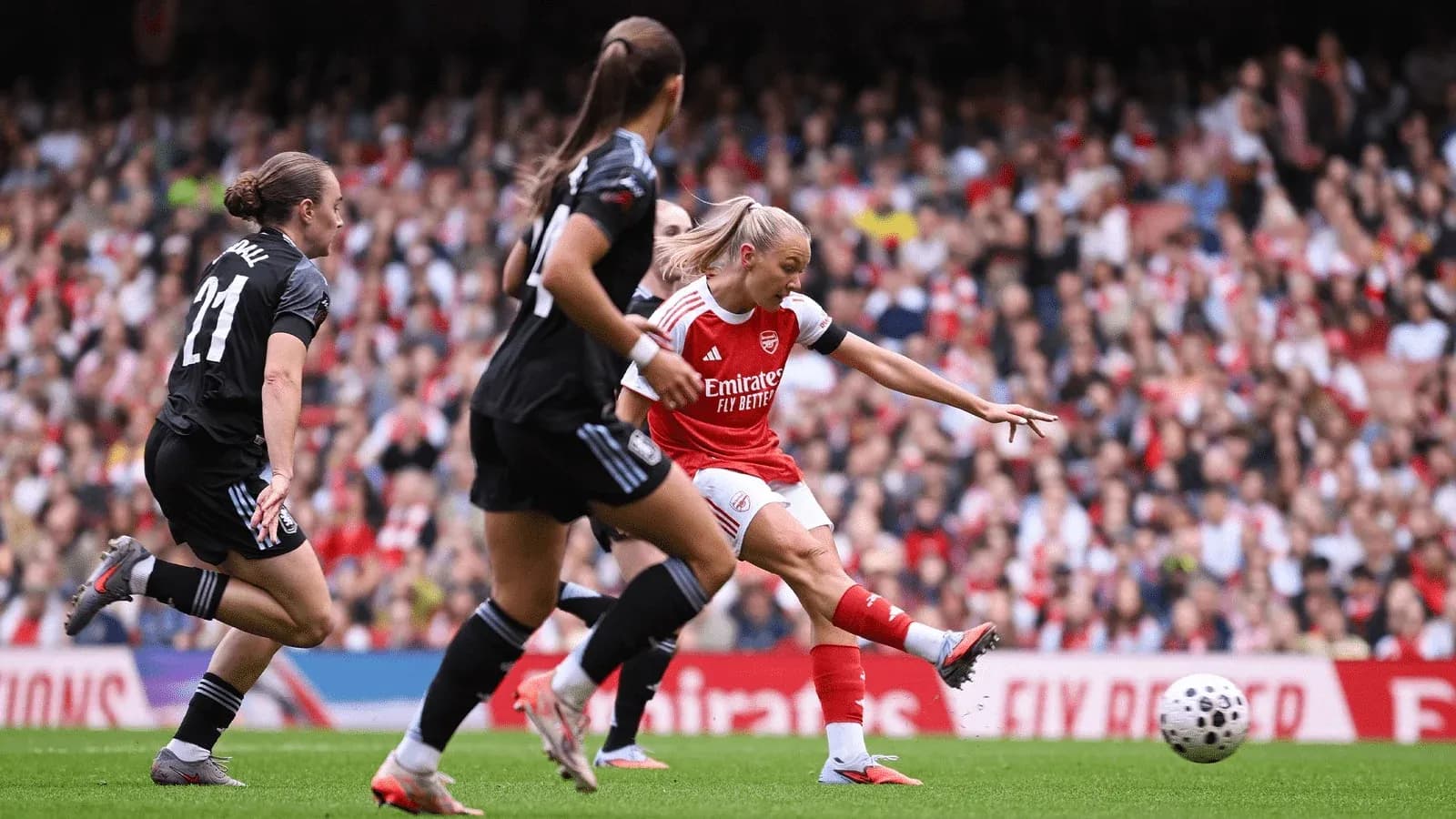 Arsenal player shooting during match against Aston Villa