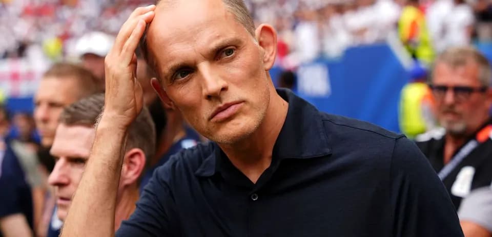 Coach observing the match with concerned expression