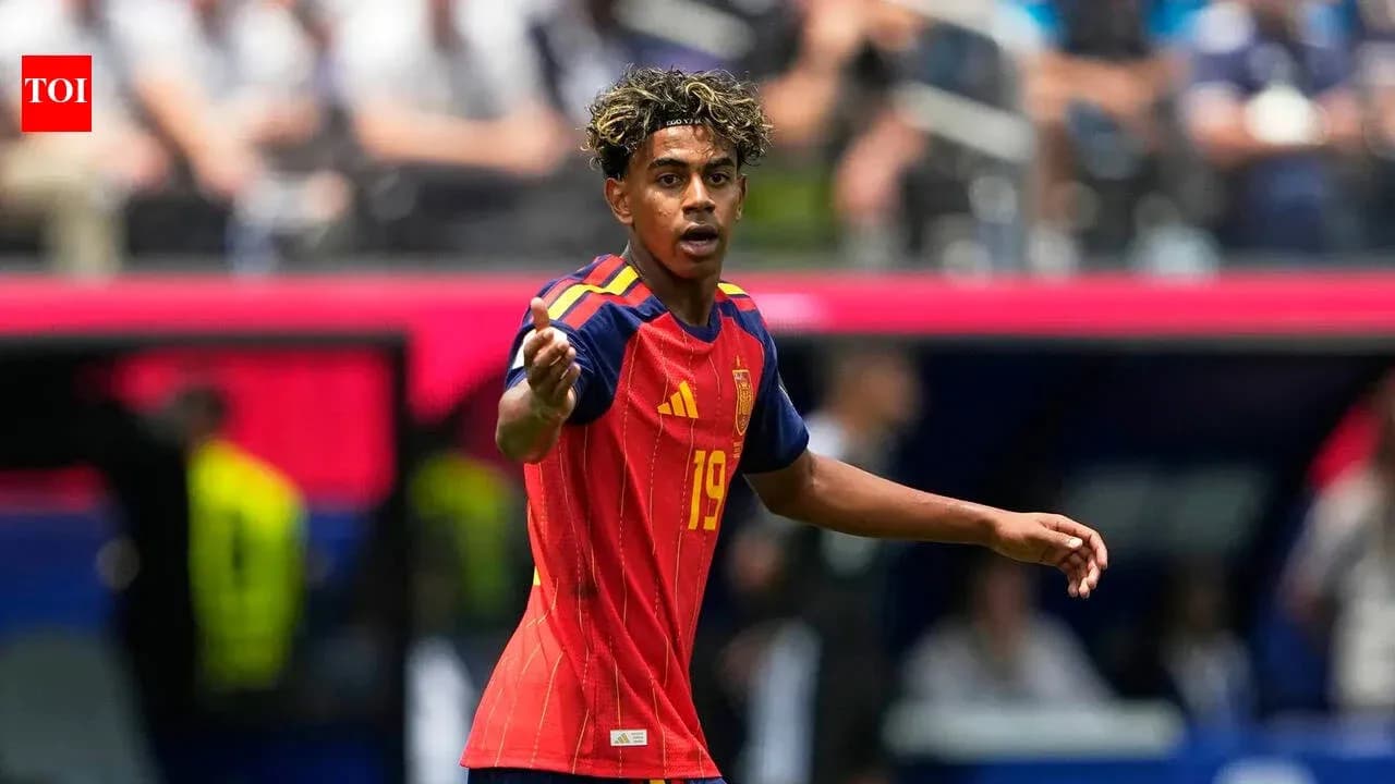 Player in red Spain jersey gesturing during match
