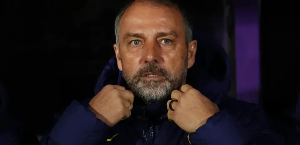 Coach adjusting his jacket on the sidelines