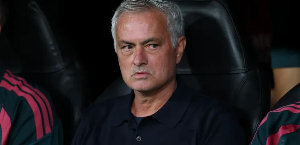 Coach sitting on bench during a match
