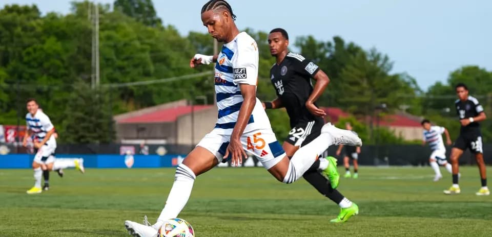 Player kicking the ball during Huntsville City match
