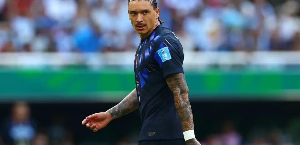 Player in blue jersey walking on field during match