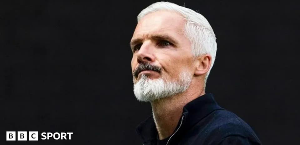 Man with white hair and beard in dark background