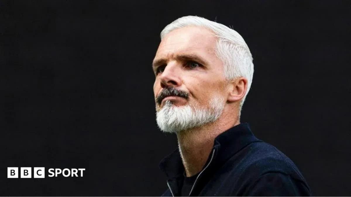 Man with white hair and beard in dark background