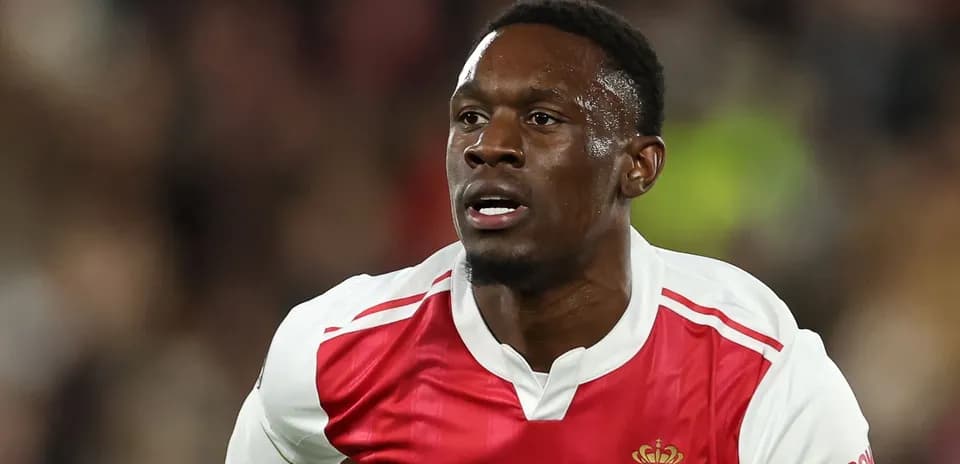 Player running during a football match wearing Monaco kit
